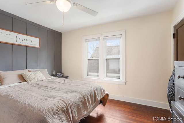 bedroom with ceiling fan, hardwood / wood-style flooring, and baseboards