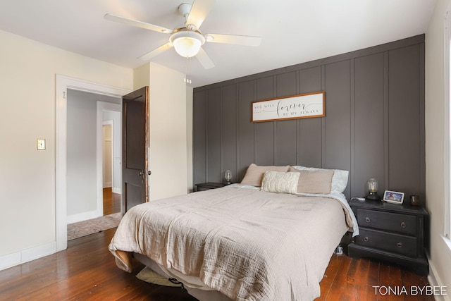 bedroom featuring a ceiling fan, dark wood-style flooring, and baseboards