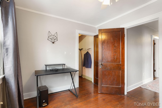 corridor with baseboards, vaulted ceiling, ornamental molding, and dark wood finished floors