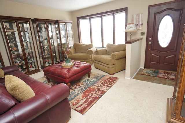 living area featuring carpet and baseboards