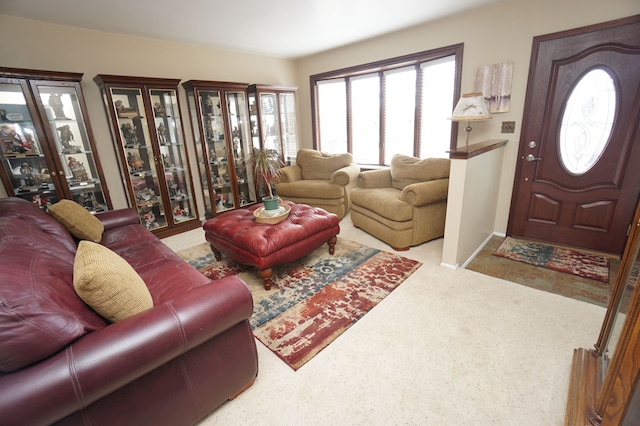 living room featuring carpet and baseboards