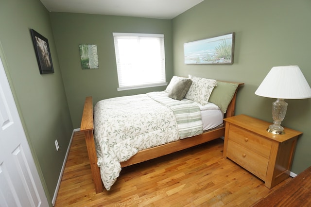 bedroom with baseboards and wood finished floors