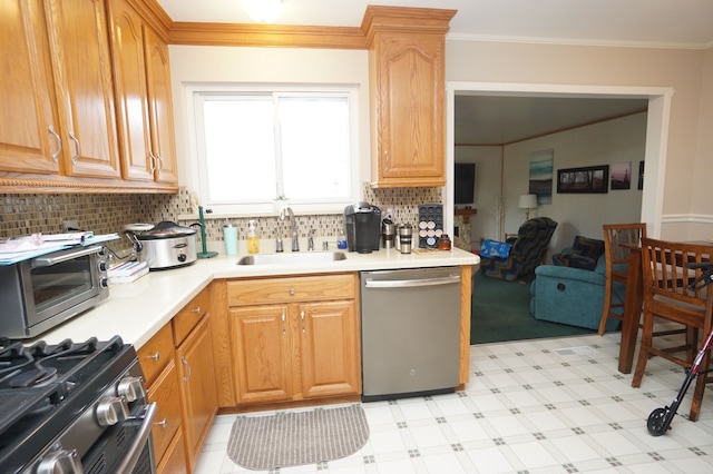 kitchen featuring stainless steel appliances, crown molding, light countertops, light floors, and a sink