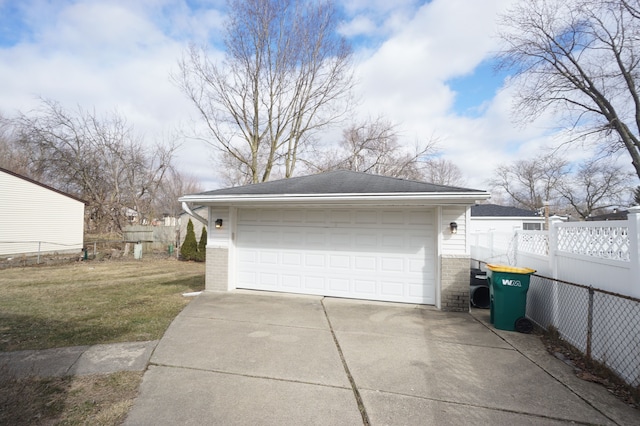 detached garage featuring fence