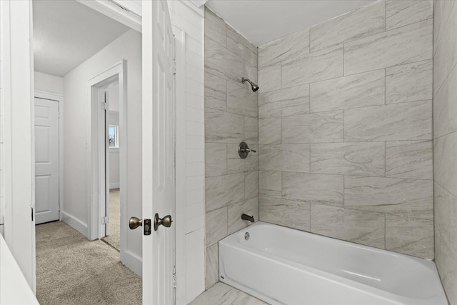 bathroom featuring shower / washtub combination and baseboards