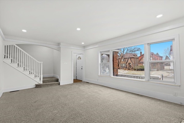 unfurnished living room with stairway, recessed lighting, carpet flooring, and baseboards