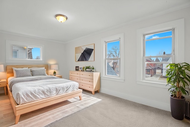 bedroom with light carpet, baseboards, and crown molding