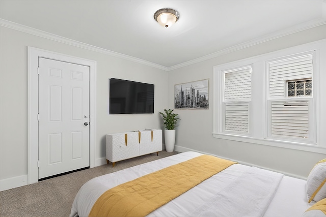 bedroom with carpet floors, baseboards, and crown molding