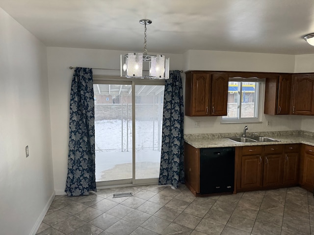 kitchen with black dishwasher, baseboards, visible vents, decorative light fixtures, and a sink