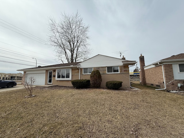 view of front of home featuring a garage, concrete driveway, brick siding, and a front lawn