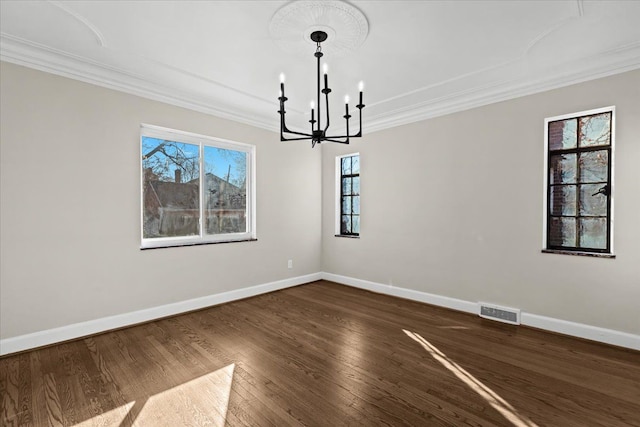 interior space featuring crown molding, a notable chandelier, visible vents, and plenty of natural light