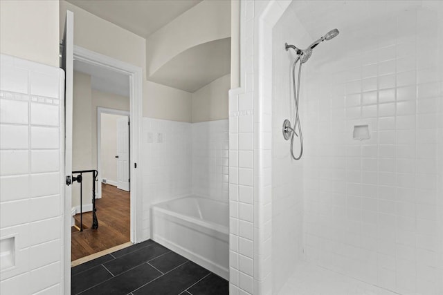 full bathroom with tile patterned floors, a tile shower, and a washtub