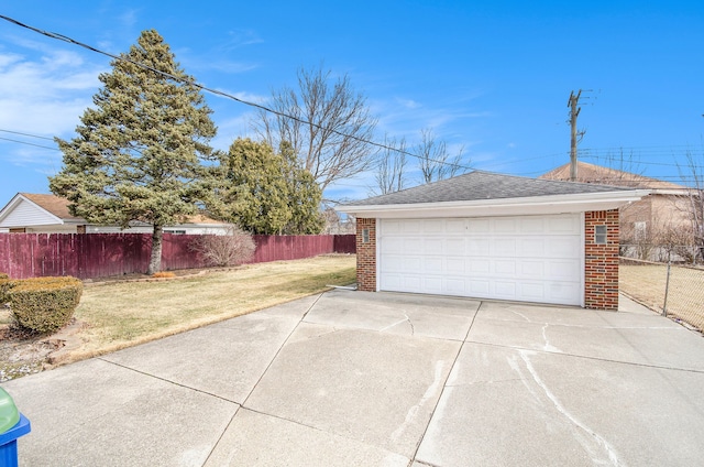 detached garage featuring fence