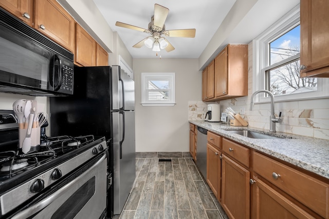 kitchen with a sink, tasteful backsplash, brown cabinets, and stainless steel appliances