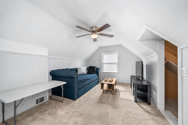 additional living space featuring visible vents, ceiling fan, carpet, and lofted ceiling