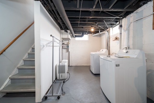 below grade area featuring stairway and washer and clothes dryer