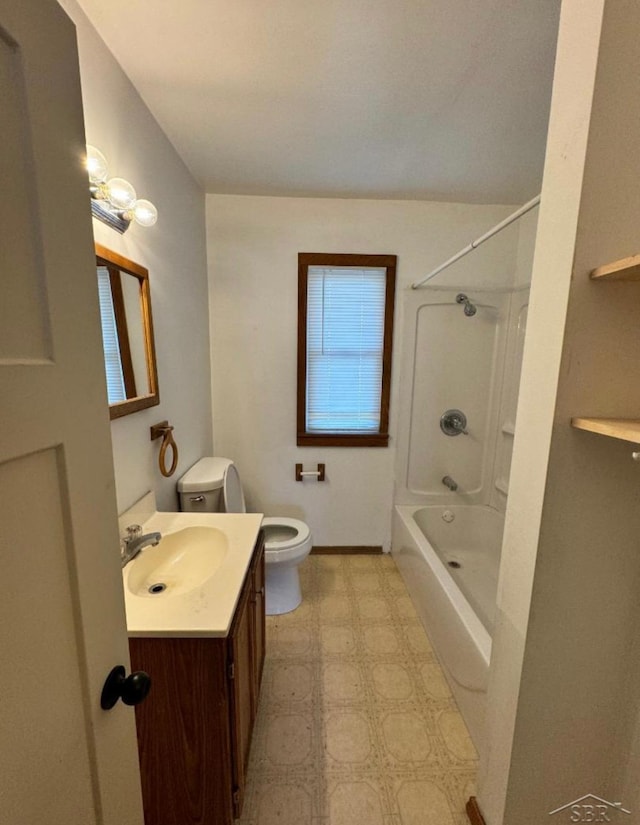 bathroom with baseboards, toilet, tile patterned floors, vanity, and shower / washtub combination