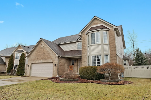 traditional home with fence, driveway, a front lawn, a garage, and brick siding