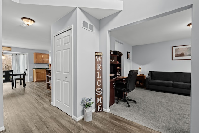 office space with visible vents, baseboards, and wood finished floors