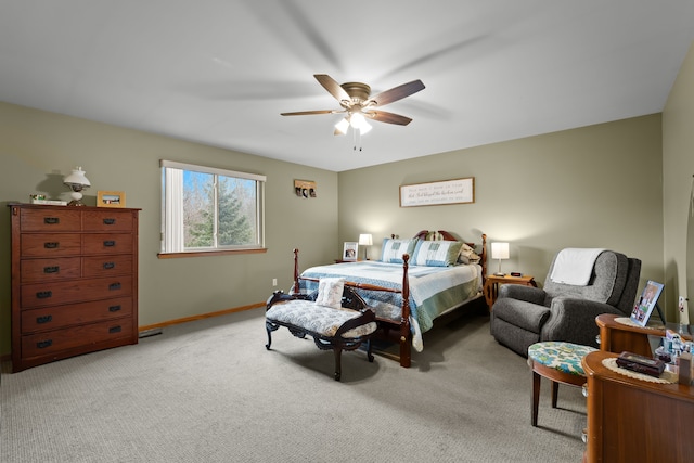 bedroom with visible vents, light colored carpet, a ceiling fan, and baseboards