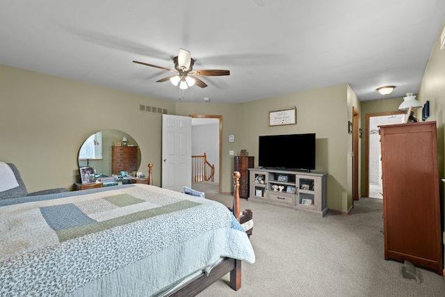 carpeted bedroom featuring baseboards, visible vents, and ceiling fan