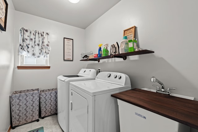 laundry area featuring laundry area, light tile patterned flooring, and washer and clothes dryer