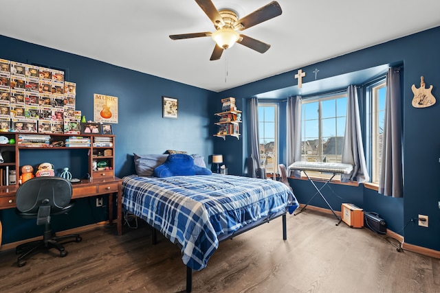 bedroom with baseboards, wood finished floors, and a ceiling fan