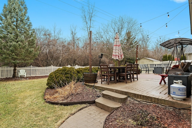 view of yard with a patio area, outdoor dining space, an outdoor structure, and fence