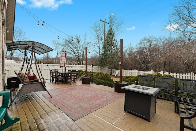 view of patio with outdoor dining area and a fenced backyard