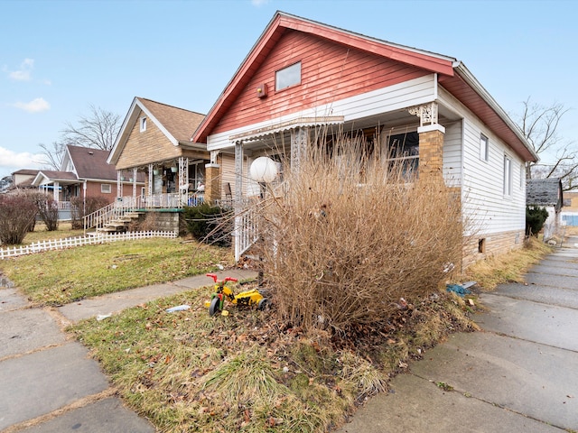 bungalow featuring a front lawn and a porch