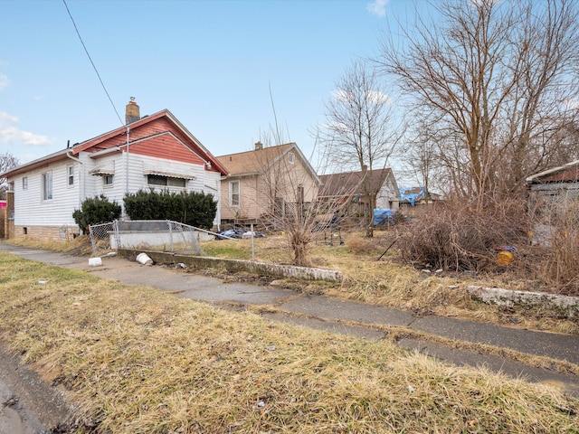 view of front of property with a fenced front yard and a chimney