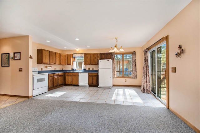 kitchen featuring light tile patterned flooring, light carpet, white appliances, baseboards, and dark countertops