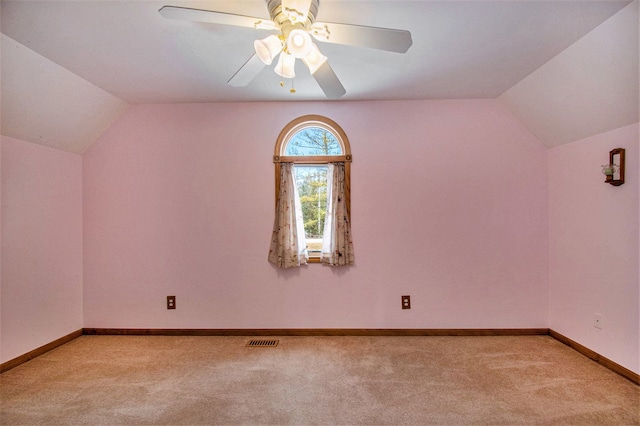 bonus room with baseboards, visible vents, vaulted ceiling, and light colored carpet