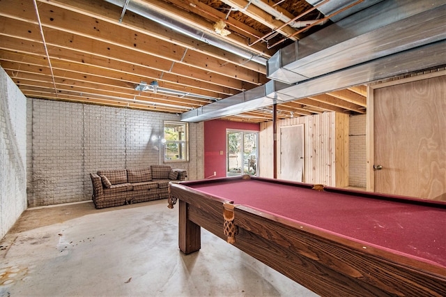 rec room with brick wall, concrete floors, and billiards