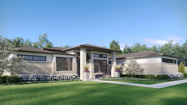 prairie-style home with stucco siding, brick siding, and a front lawn