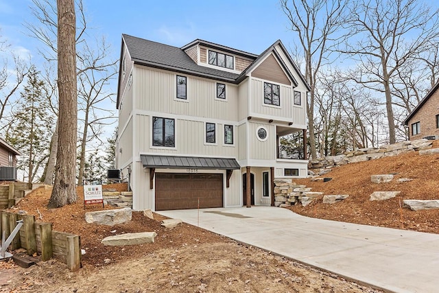 view of front facade featuring driveway, a garage, and board and batten siding