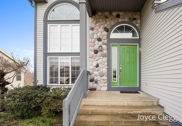 doorway to property with stone siding