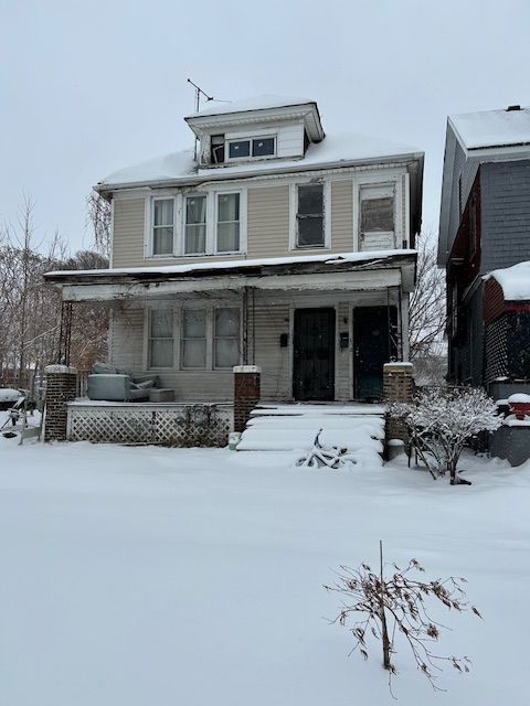 american foursquare style home with a porch