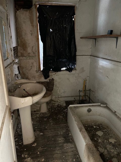 full bath with a tub to relax in, wood-type flooring, and toilet