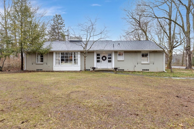 ranch-style house featuring brick siding, a front lawn, and roof with shingles