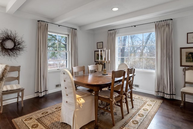 dining space with baseboards, beamed ceiling, and wood finished floors