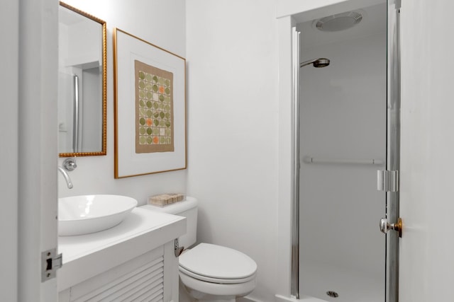 full bathroom featuring toilet, a stall shower, and vanity