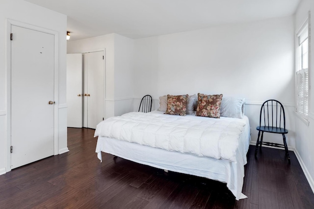 bedroom featuring baseboards and wood finished floors