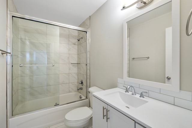 full bath featuring bath / shower combo with glass door, vanity, and toilet