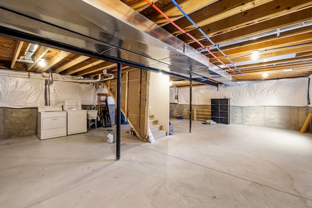 unfinished below grade area featuring a sink, stairs, and washer and dryer