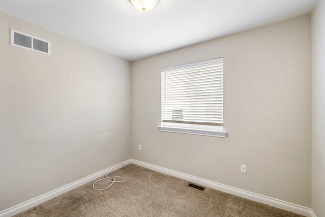 unfurnished room featuring visible vents and baseboards