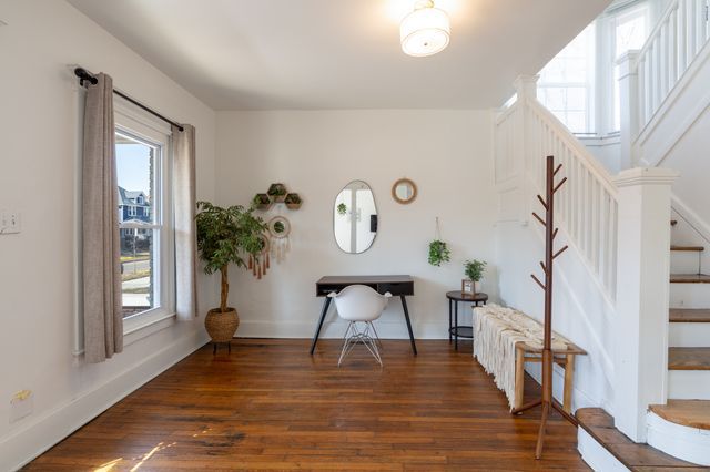 interior space featuring stairs, wood finished floors, and baseboards