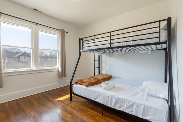 bedroom featuring baseboards, visible vents, and hardwood / wood-style floors