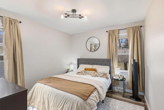 bedroom with wood finished floors and baseboards