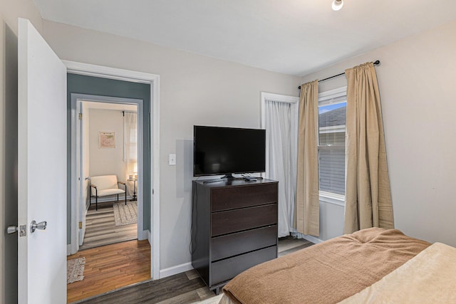 bedroom featuring wood finished floors and baseboards